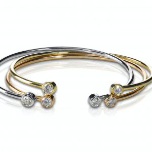 Set of three colored gold and diamond bracelets stacked